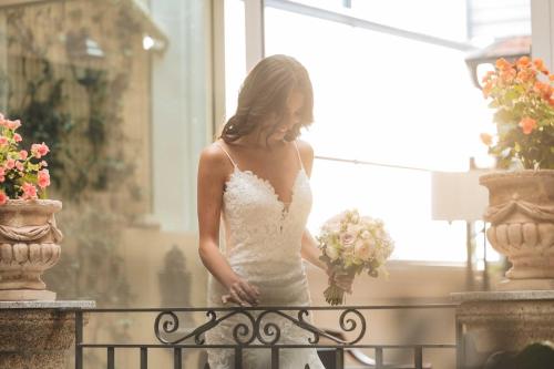 a woman in a wedding dress standing on a fence at Le Corti - Dimora storica in Polistena