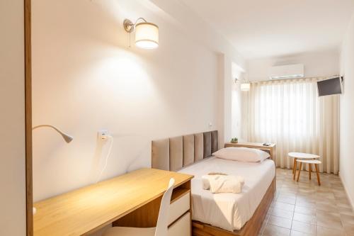 a bedroom with a bed and a desk in it at Rooms4you 1 in historic center of Braga in Braga
