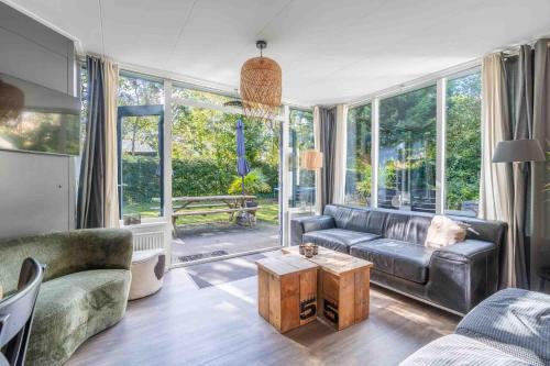 a living room with a couch and a table at Pelikaanweg 21 in De Koog