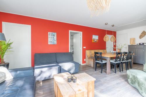 a living room with a couch and a table at Pelikaanweg 21 in De Koog