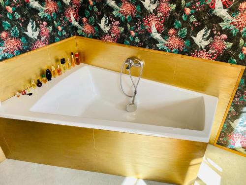 a bath tub in a bathroom with a christmas wallpaper at Birkenhof, Haus Märli in Herisau