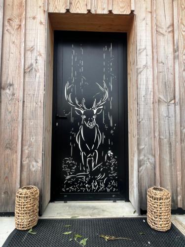 a door with a painting of a deer on it at Gîte de l’Ambiance in Francheville