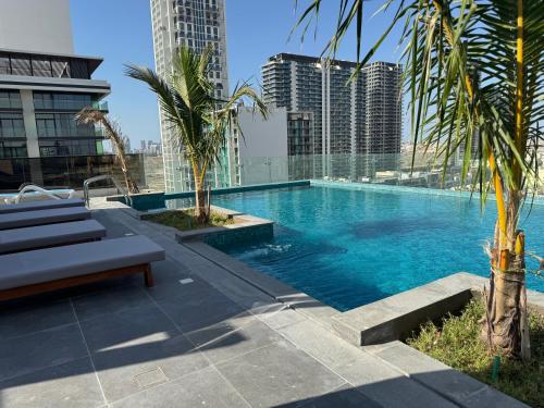 a swimming pool on top of a building with skyscrapers at Jumeirah Heights in Dubai