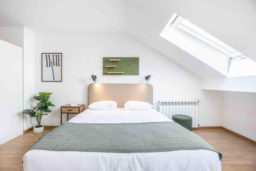 a bedroom with a large bed in a attic at Saint Laurent 33-35 by Homenhancement in Lausanne