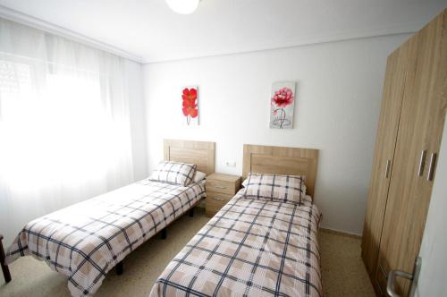 Postel nebo postele na pokoji v ubytování Livingtarifa Casa Del Mar