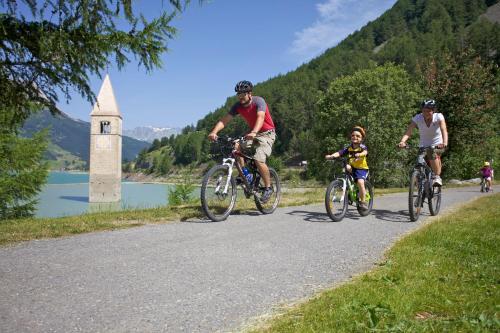 a group of people riding bikes down a road at Apart Diamant in Nauders