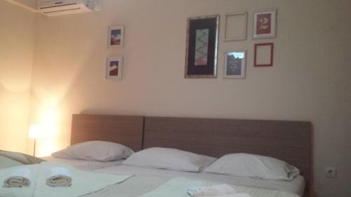 a bedroom with a bed with white sheets and pillows at Apartments Fortunella in Budva