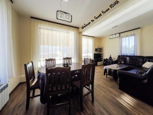 a living room with a table and a couch at Divna Guest House in Dospat