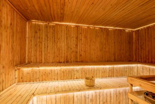 an empty wooden sauna with a bucket in it at The Emin Pasha Hotel & Spa Kampala in Kampala