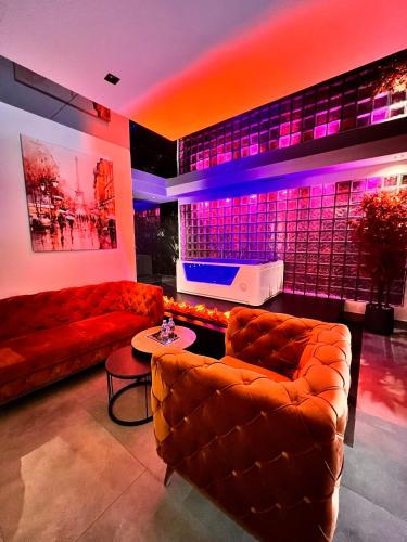 a living room with two couches and a stage at Motel Villa Princi in Kosovo Polje