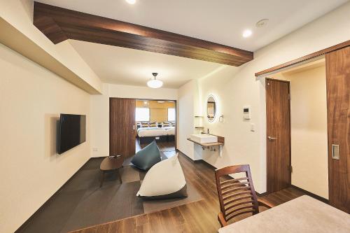 a living room with a table and chairs and a room at Asakusa Eight -Tokyo Condominium Hotel- in Tokyo
