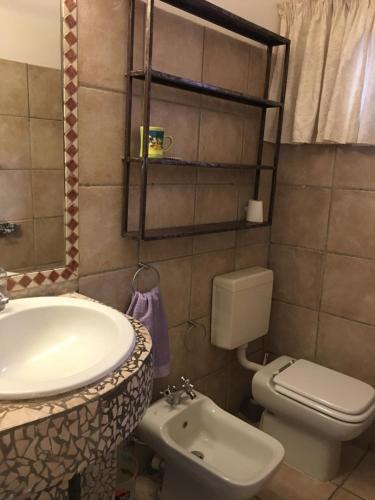 a bathroom with a sink and a toilet at tropical oasis in Ouakam