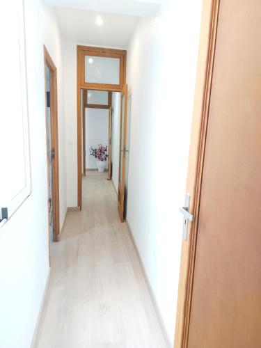 an empty hallway with a door leading into a room at Salvador House II in Elche