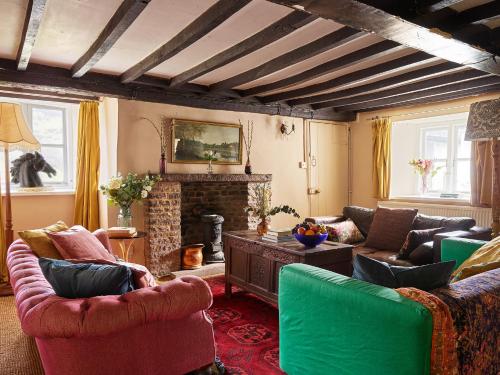 a living room with couches and a fireplace at The Castle, Capel-y-Ffin, The Black Mountains in Abergavenny