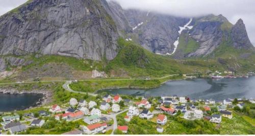 an aerial view of a village in front of a mountain at House by the sea Reine, Lofoten in Reine
