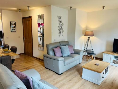 a living room with a couch and a table at The Galleries No 2 in Spean Bridge