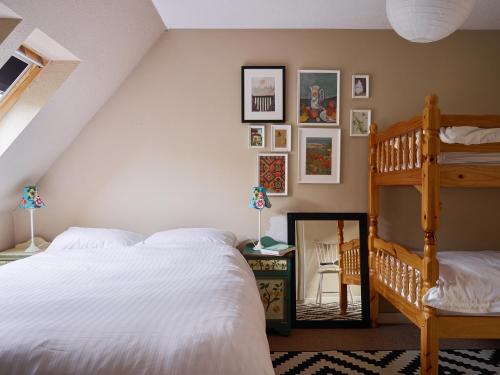a bedroom with a white bed and a ladder at The Castle, Capel-y-Ffin, The Black Mountains in Abergavenny