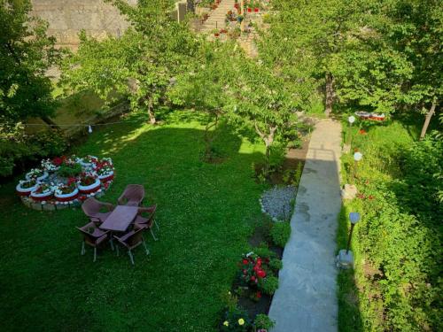 an overhead view of a garden with a table and chairs at Pacific Guest House Skardu in Skardu