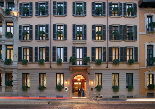 a large building with people standing outside of it at Mandarin Oriental, Milan in Milan