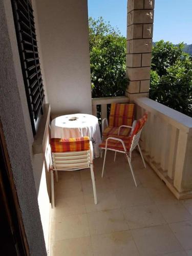 a patio with a table and chairs on a balcony at Apartment Tina in Brna