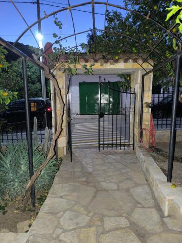 a garage with a door with a tree in front of it at HoneyHouse in Kádhion