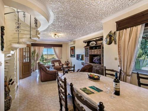 a dining room and living room with a table and chairs at VILLA SALGADOS, near ALBUFEIRA, with Private Pool, 5 minutes from Gale Beach in Guia