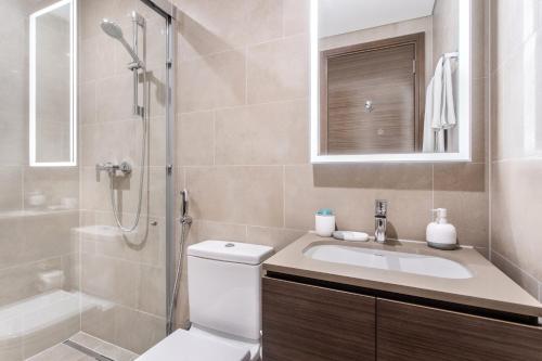 a bathroom with a toilet and a sink and a shower at STAY BY LATINEM Luxury 2BR Holiday Home CV A813 near Burj Khalifa in Dubai