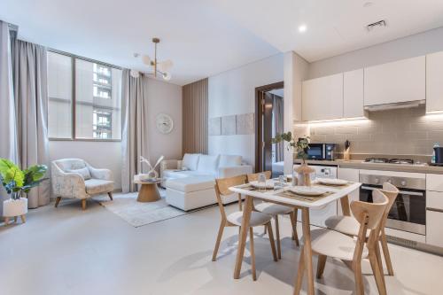 a kitchen and living room with a table and chairs at STAY BY LATINEM Luxury 2BR Holiday Home CV A813 near Burj Khalifa in Dubai