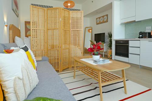 a living room with a couch and a table at Studio Apartment with Beautiful View in Abu Dhabi