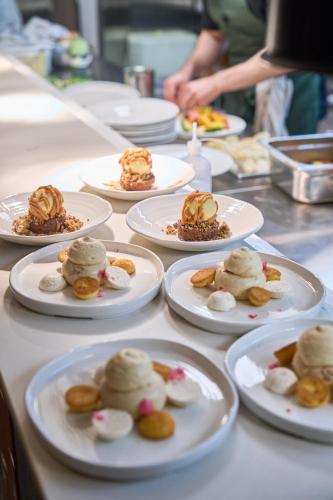 a table with plates of desserts on them at Naantali Spa Hotel in Naantali