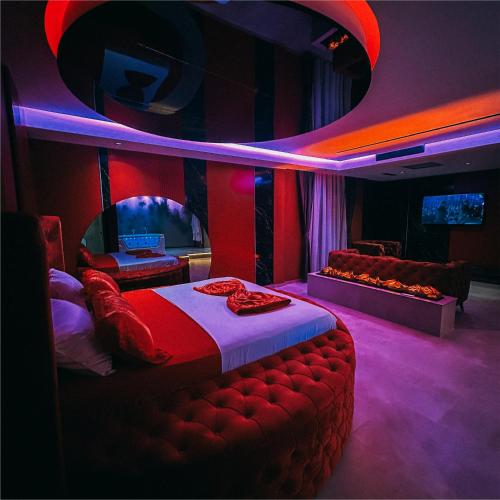 a room with a bed and a couch and a tv at Motel Villa Princi in Kosovo Polje