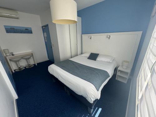 a bedroom with a bed in a blue room at La Pergola d'Arcachon in Arcachon