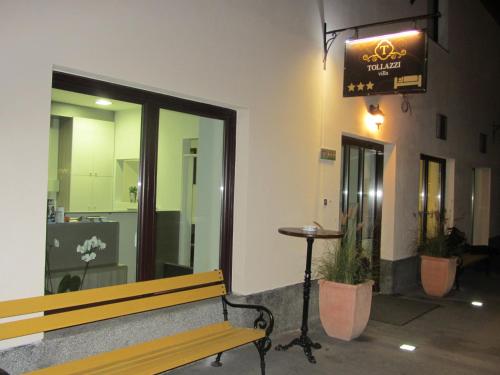a bench in front of a building with a sign at Villa Tollazzi in Logatec