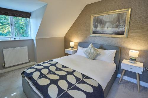 a bedroom with a large bed and two night stands at Host & Stay - Danford Court in Solihull