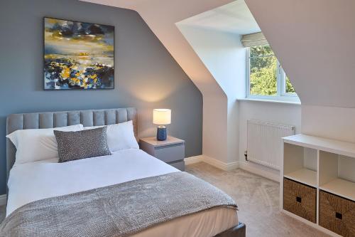 a bedroom with a white bed and a window at Host & Stay - Danford Court in Solihull