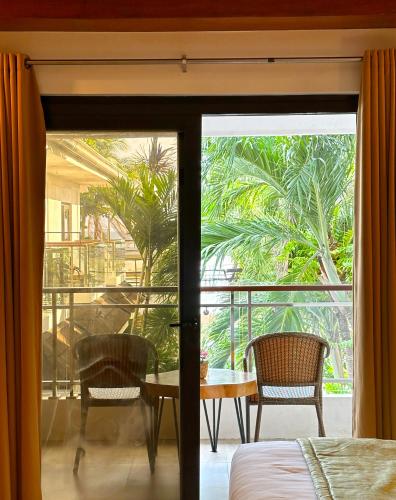 a bedroom with a door open to a balcony at Jony's Beach Resort in Boracay