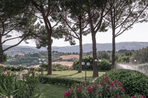 a view of a garden with trees and flowers at Hotel Bramante in Todi