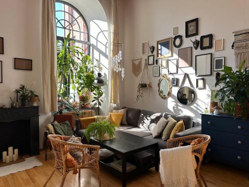a living room with a couch and a table at Studio Włókno - słoneczny loft u Scheiblera in Łódź