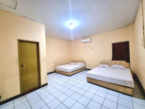 Ένα ή περισσότερα κρεβάτια σε δωμάτιο στο Hotel Harapan Jaya