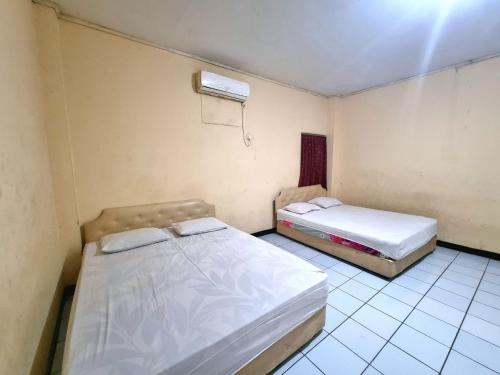 Ένα ή περισσότερα κρεβάτια σε δωμάτιο στο Hotel Harapan Jaya