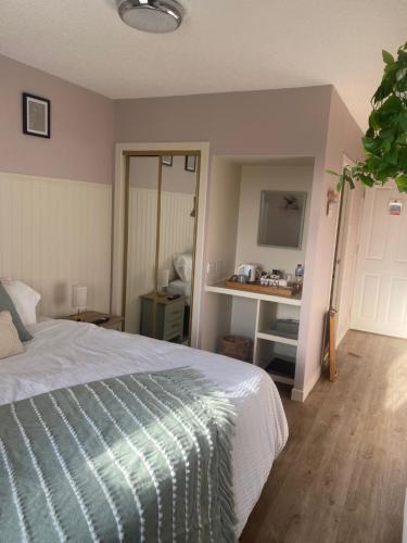 a bedroom with a bed and a desk at Carnegie Lodgings, Tain in Tain