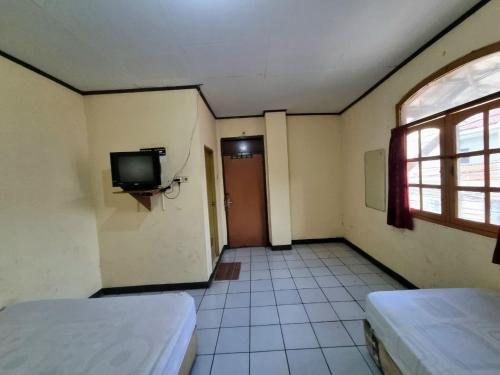 Ένα ή περισσότερα κρεβάτια σε δωμάτιο στο Hotel Harapan Jaya