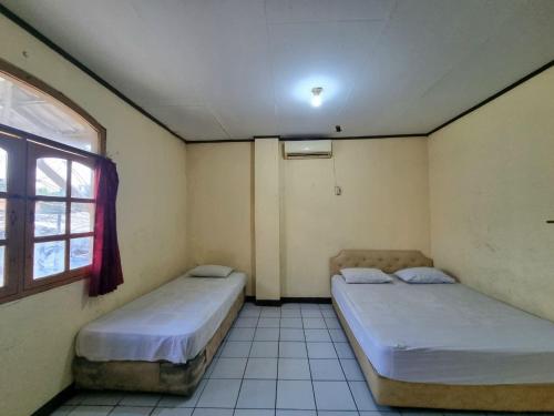 Ένα ή περισσότερα κρεβάτια σε δωμάτιο στο Hotel Harapan Jaya