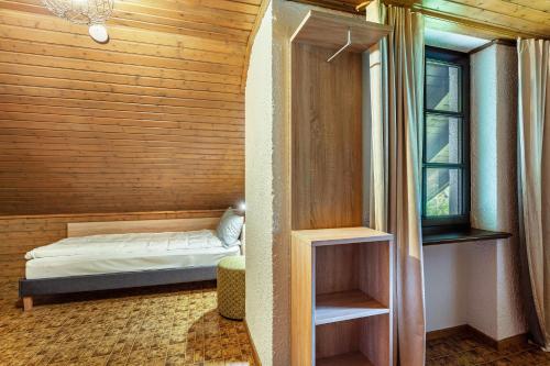 a small bedroom with a bed and a window at Azalea in Olsberg