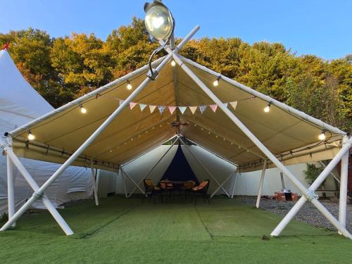 a tent with a table and lights on it at Gapyeong Full Room Detached Pension in Gapyeong