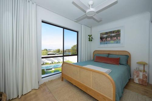 a bedroom with a bed and a large window at Warm Heated Pool All Year - Palm Springs in Torquay