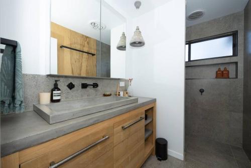 a bathroom with a sink and a shower at Warm Heated Pool All Year - Palm Springs in Torquay