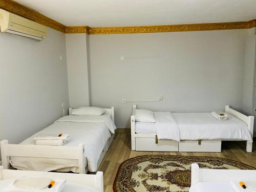 a room with two beds and a rug at Stylish Hotel Old City in Istanbul