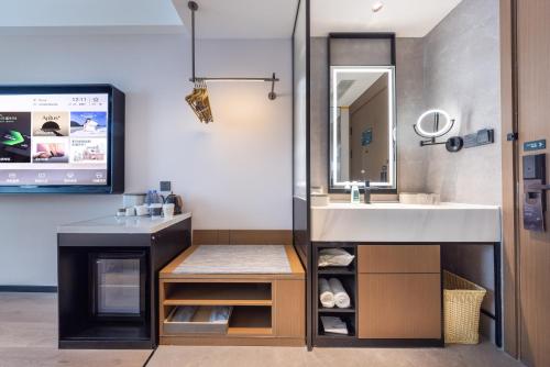 a bathroom with a sink and a mirror at Atour Hotel Chengdu Sichuan University North Kehua Road in Chengdu
