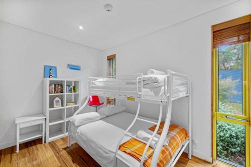a bedroom with a bunk bed with a ladder at Aireys Bush Retreat in Aireys Inlet